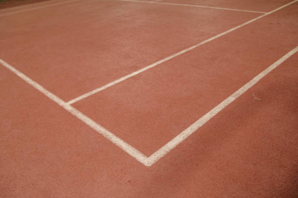 istock An empty tennis court at night, lit by bright lights 1158574652