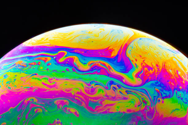 istock Macro shot of a soap bubble hemisphere. Abstract colorful liquid background. 1158576381
