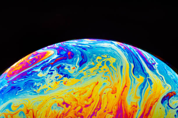 istock Macro shot of a soap bubble hemisphere. Abstract colorful liquid background. 1158576384
