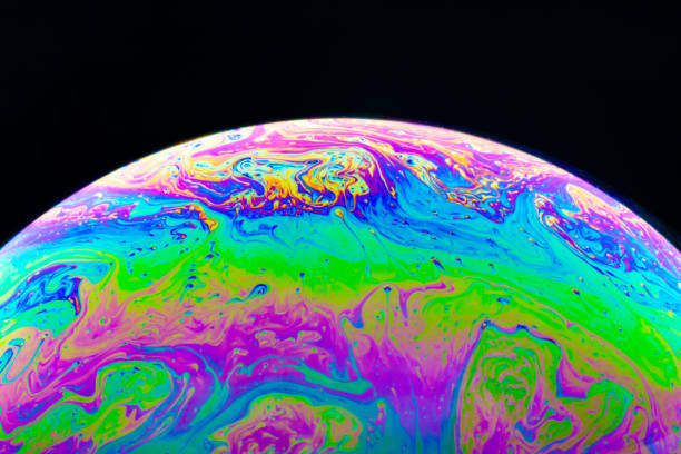 istock Macro shot of a soap bubble hemisphere. Abstract colorful liquid background. 1158576385