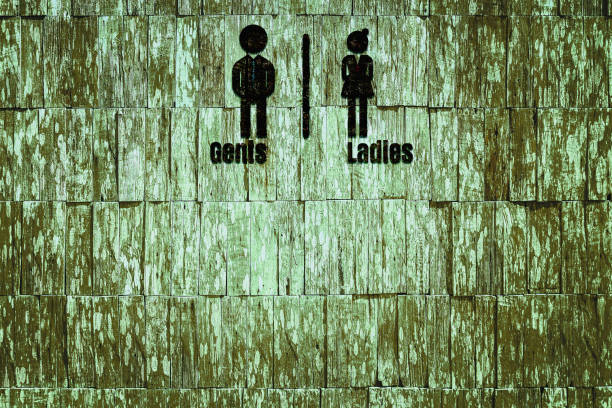 Public restroom sign on a wood board.