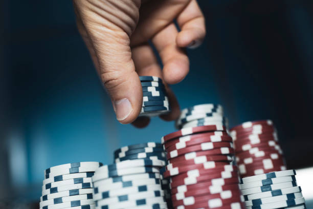 istock Successful man stacking poker chips at the casino 1158579983