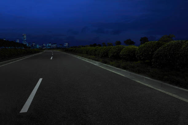 view of asphalt road and night sky