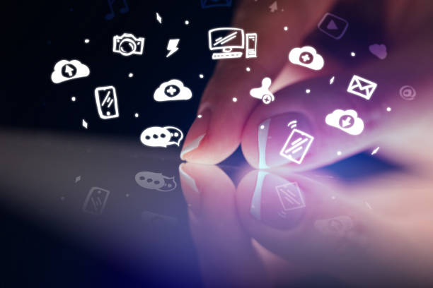 istock Finger touching tablet with white app icons above 1158580814
