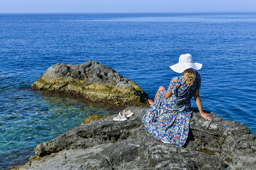 Woman on the rocky beach.
