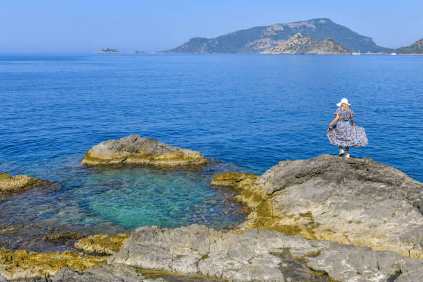Woman on the rocky beach.
