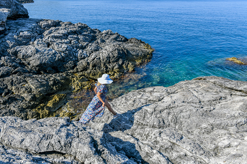 Woman on the rocky beach.