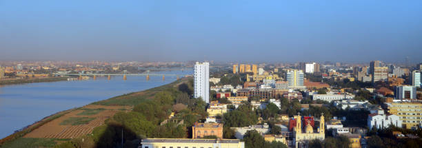 Khartoum downtown and North skyline - wide panorama of the Sudanese capital and the Blue Nile river, Sudan Khartoum, Sudan: skyline of the Sudanese capital - wide panorama of the downtown area, waterfront along the Blue Nile river, government buildings, presidential palace, churches... Bridges to Khartoum North / Khartoum Bahri. khartoum stock pictures, royalty-free photos & images