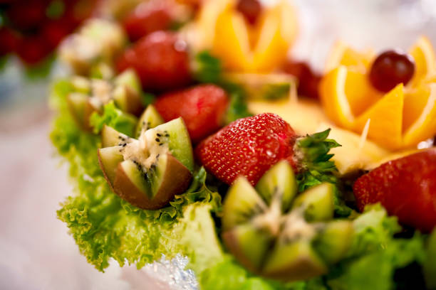 istock Fresh, exotic, organic fruits, light snacks in a plate on a buffet table. Assorted mini delicacies and snacks, restaurant food at event. Strawberries in a glass bowl on the white table 1158592150