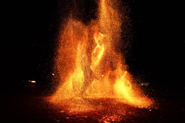 istock Fire show, dancing with flame, male master juggling with fireworks, performance outdoors, 1158592197