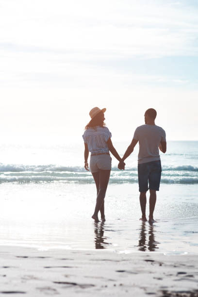 istock The beach sets the perfect background to their love 1158592893