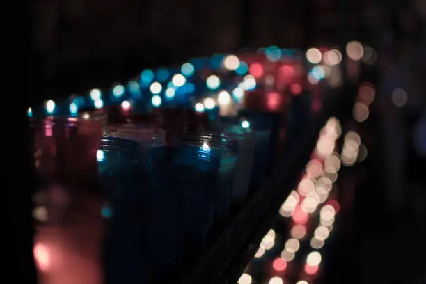 A lot of colorful candles glowing in Covadonga, Asturias, Spain. Religious symbol of the spanish reconquest by King Pelayo