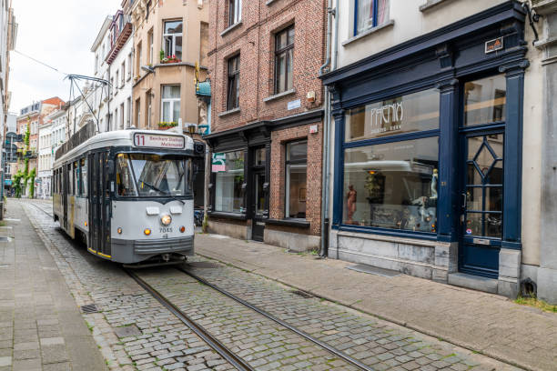 Antwerp, Belgium - June 23 2019: Public transport trams on the street in the middle of Antwerp, Belgium.