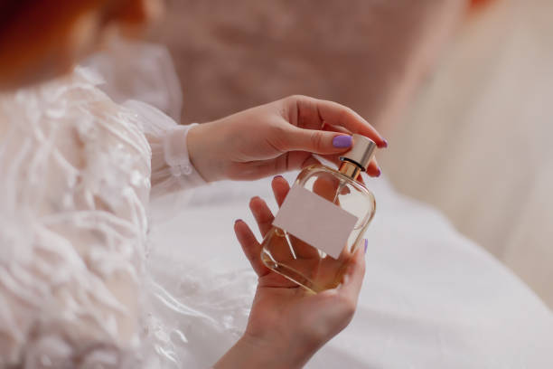 This image has an empty alt attribute; its file name is beautiful-bride-holds-in-hands-female-perfume.jpg