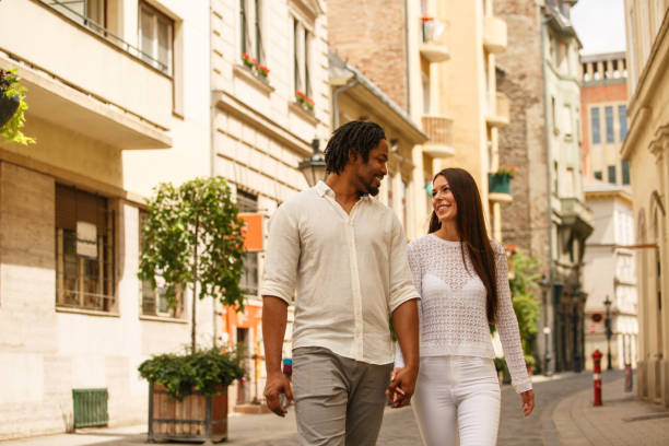 istock Couple walking down the city street 1158602155