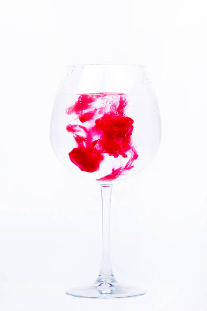 istock Pink paint falls in a wineglass with water 1158602711
