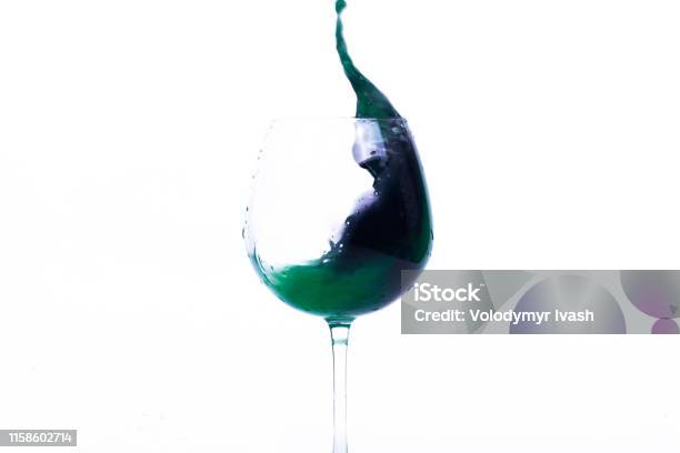 Green And Violet Water Splashes In A Wineglass Stock Photo - Download Image Now - Advertisement, Celebration, Champagne Flute