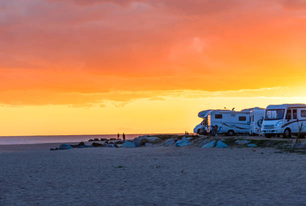 Barcellona, Spain - Jan.02.2016.Motor homes, camper vans at sunset beach copy space.Travel adventure vacation in camping.