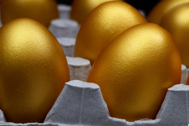 istock Tray of eggs with golden eggs side view 1158604601