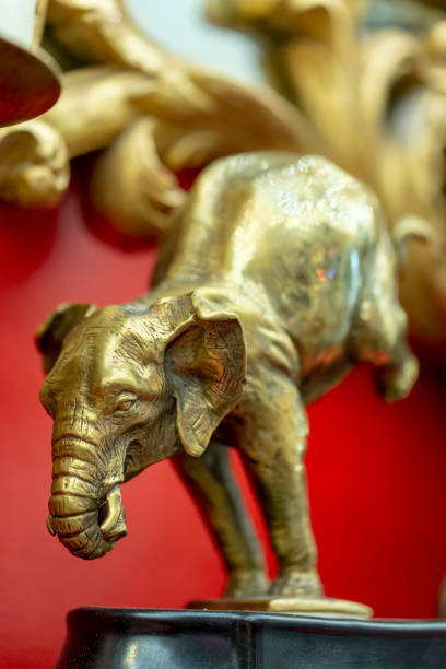 istock bronze statuette of an elephant in a interior red background 1158604617