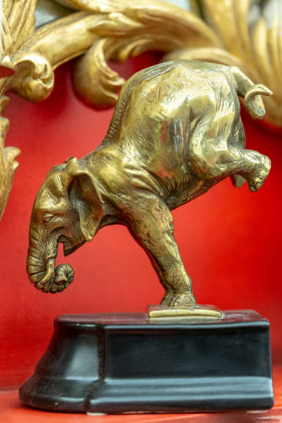 istock bronze statuette of an elephant in a interior red background 1158605206
