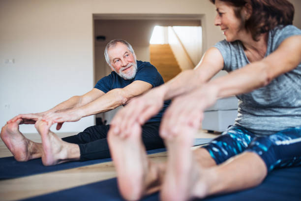 istock A senior couple indoors at home, doing exercise on the floor. 1158605696
