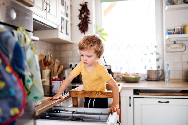 istock A small toddler boy standing in a kitchen at home. 1158606926