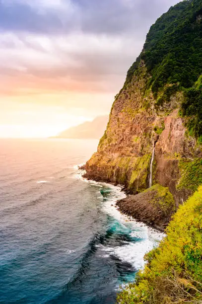 Photo of Beautiful wild coast scenery view with Bridal Veil Falls (Veu da noiva) at Ponta do Poiso in Madeira Island. Near Porto Moniz, Seixal, Portugal.