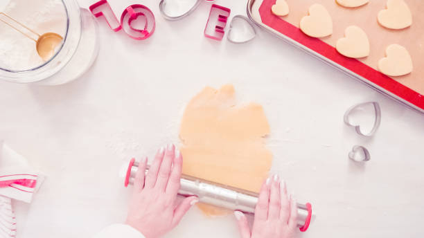 istock Rolling sugar cookie dough with metal rolling pin. 1158607862