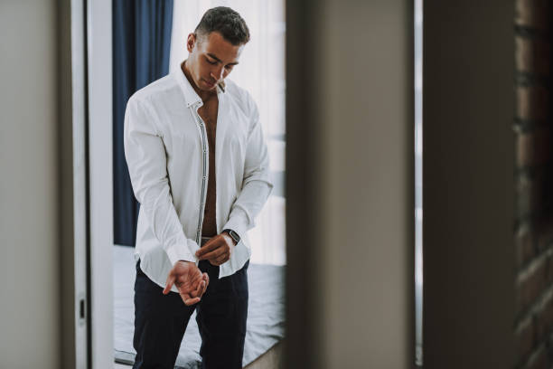 istock Young executive is dressing in his bedroom in morning 1158607879