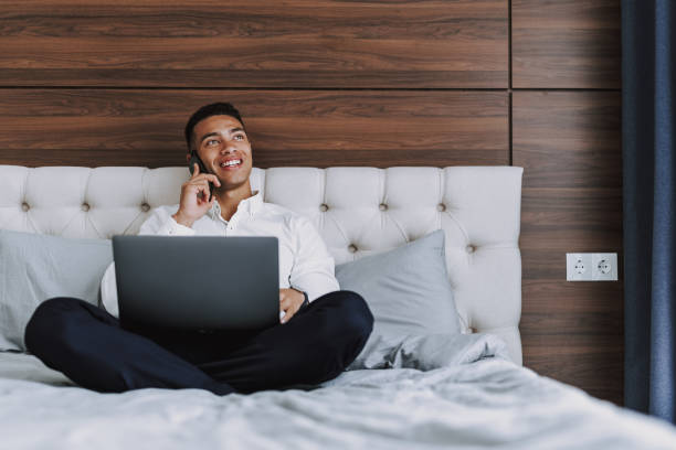 istock Jolly businessman with gadgets is relaxing in hotel 1158607882