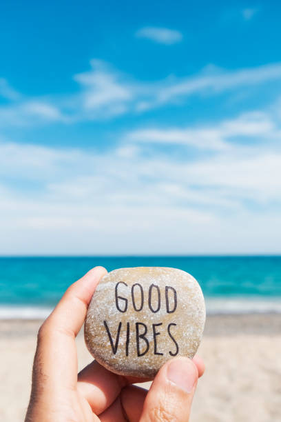 istock text good vibes in a stone on the beach 1158609273