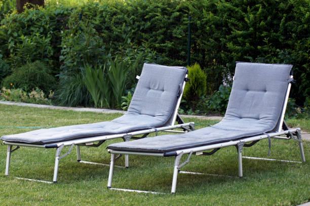 Two sun loungers on the green meadow