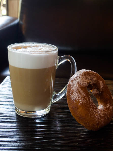 istock delicious donut and cup of coffee latte 1158610519