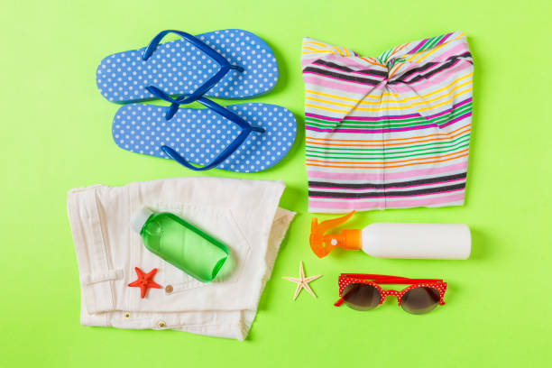 istock Flat lay composition with Beach accessories on green color background. Summer holiday background. Vacation and travel items top view 1158611453