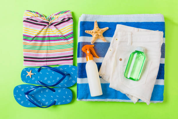 istock Flat lay composition with blue Beach accessories on green color background. Summer holiday background. Vacation and travel items top view 1158611709