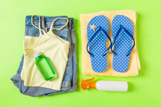 istock Flat lay composition with Beach accessories on green color background. Summer holiday background. Vacation and travel items top view 1158611800