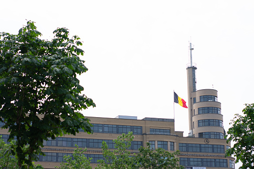 Brussels, Belgium - June 18 2018 : Belgian flag next to building, place Flagey