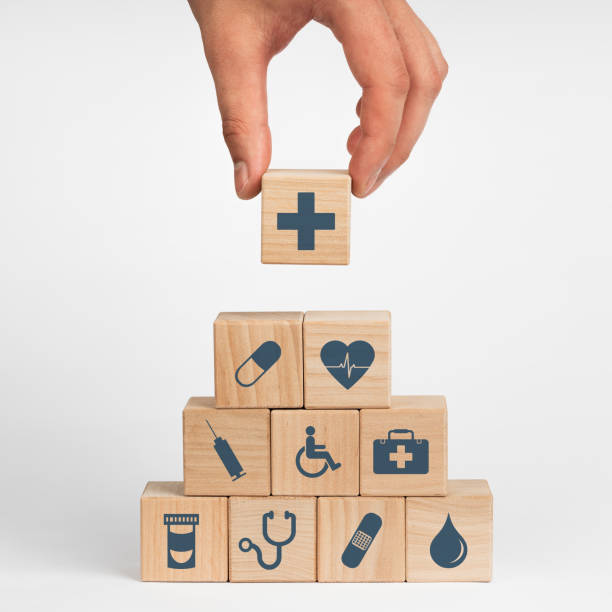 Concept of Insurance for your health, Hand hold wooden block with icon healthcare medical stock photo