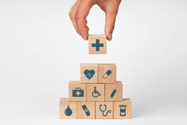 Concept of Insurance for your health, Hand hold wooden block with icon healthcare medical stock photo
