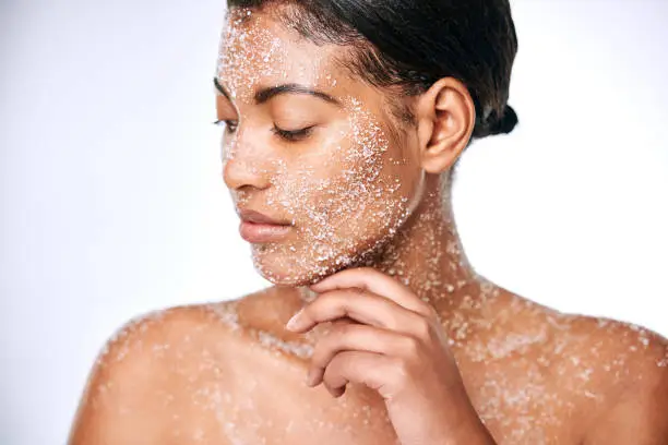 Studio shot of a beautiful young woman using sea salt in her beauty routine