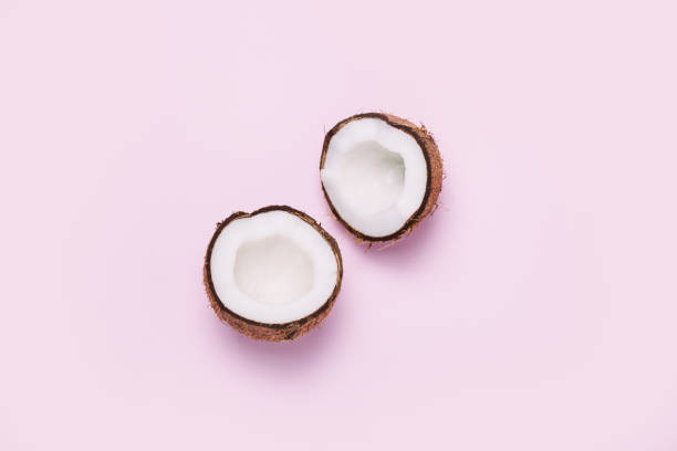 Coconut on pink background. Minimal concept. Coconut on pink background. Minimal concept. Top view, flat lay fruit of coconut tree stock pictures, royalty-free photos & images