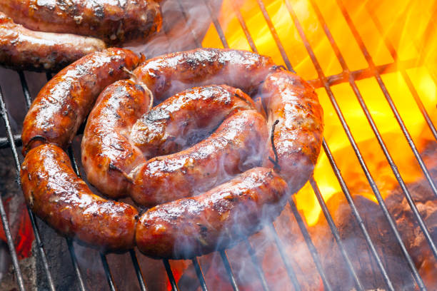 BBQ with fiery sausages on the grill BBQ with fiery sausages on the grill german food photos stock pictures, royalty-free photos & images