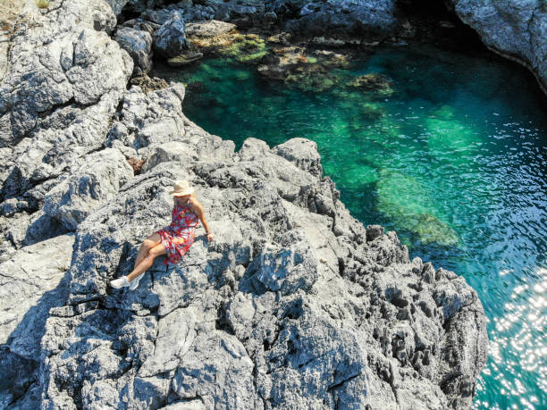 istock Woman looking at see on cliffs. 1158617919