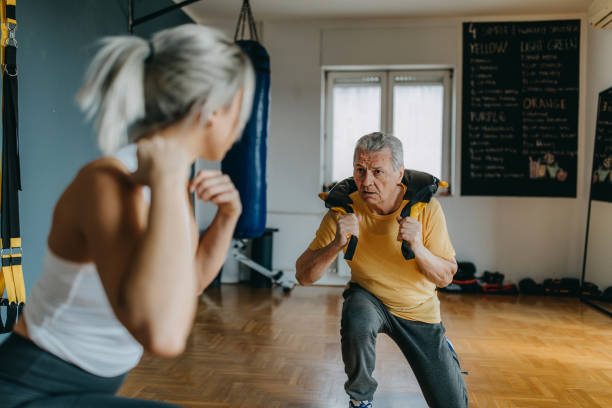 istock Senior man exercising with his personal trainer 1158618056
