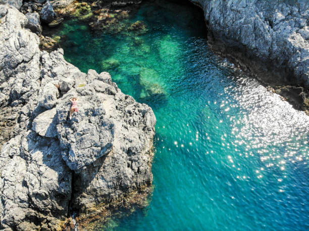 istock Woman looking at see on cliffs. 1158618070