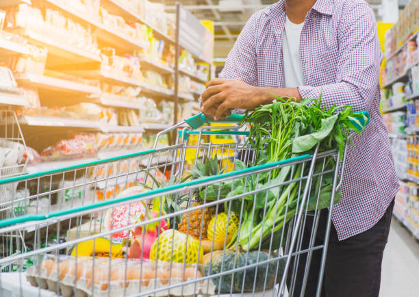 istock Young man shopping at supermarket. 1158618092