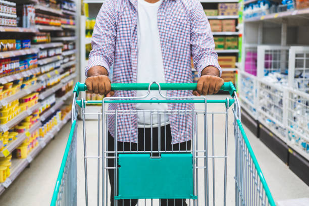 istock Young man shopping at supermarket. 1158618103