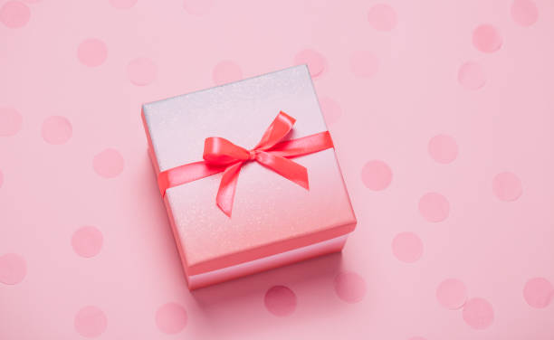 istock Pink present box on pink konfetti background. 1158618426