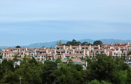 Hillside housing development sports tile roofs and blue awnings. Los Altos, California.